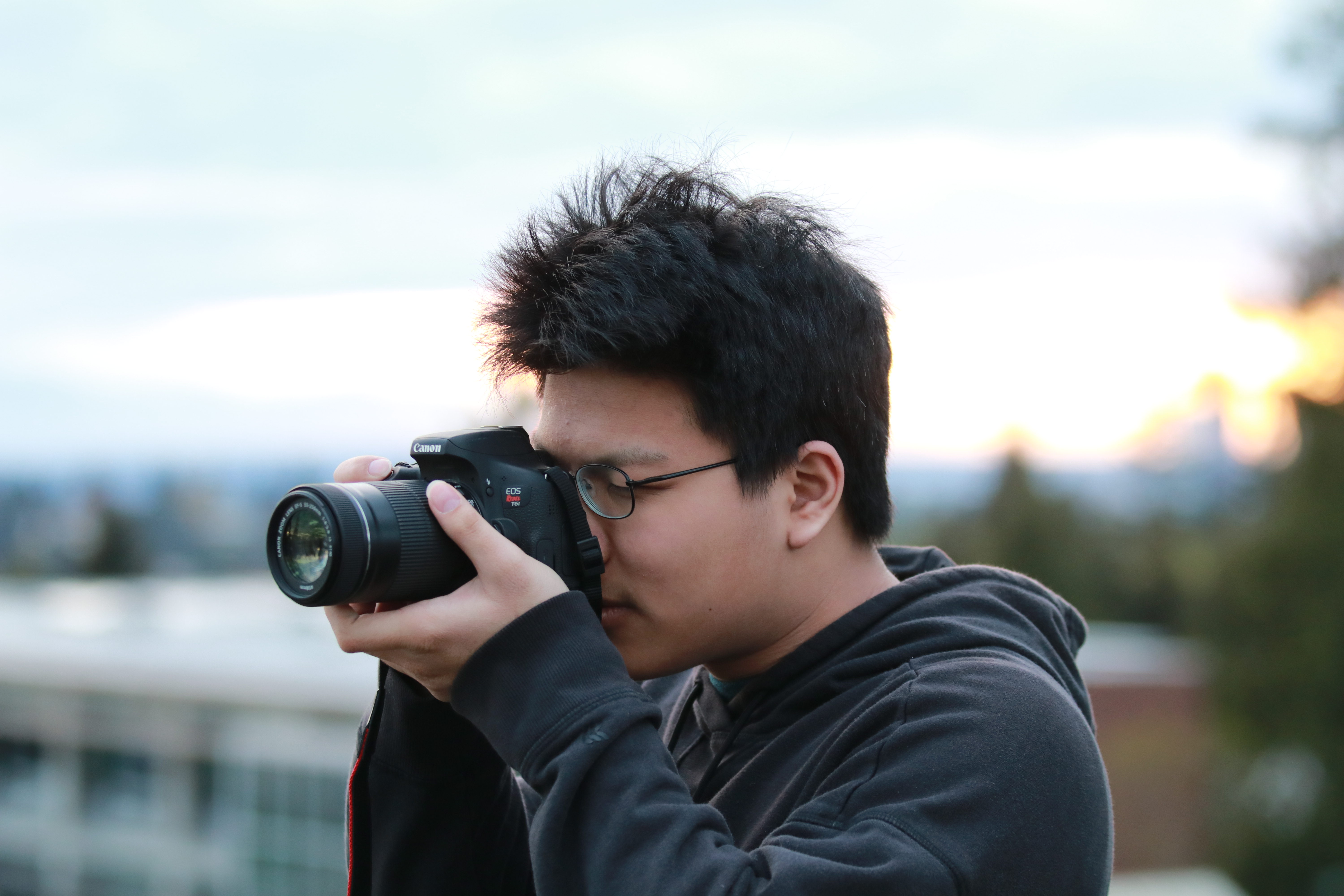 Thomas taking a photo with a DSLR camera